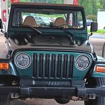 Green Jeep Wrangler, front
